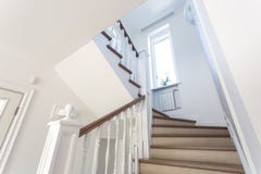 Wooden spiral staircase in bright interior in vacation house royalty free stock photo Wooden spiral staircase in bright interior in vacation house royalty free stock photo