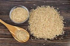 Image result for brown rice on the wooden table