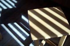 Wooden stool in the shadows of the blinds royalty free stock photography Wooden stool in the shadows of the blinds royalty free stock photography