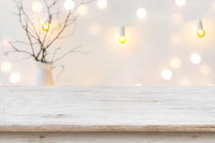 Wooden table in front of blurred abstract winter holiday background