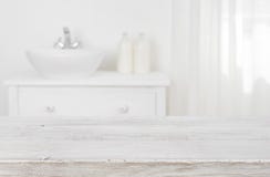 Wooden table top over blurred bathroom furniture with copy space Stock Photography Wooden table top over blurred bathroom furniture with copy space Stock Photography