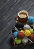 Wool yarn and knitting needles in a vintage tray, a book and a Cup of coffee royalty free stock photos Wool yarn and knitting needles in a vintage tray, a book and a Cup of coffee royalty free stock photos