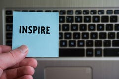 Word INSPIRE on sticky note hold in hand on keyboard background royalty free stock photos Word INSPIRE on sticky note hold in hand on keyboard background royalty free stock photos