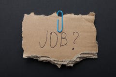 The word `Job?` on a piece of cardboard box on a black background. royalty free stock photography The word `Job?` on a piece of cardboard box on a black background. royalty free stock photography