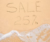 The word Sale 25% written in the sand on beach Stock Image The word Sale 25% written in the sand on beach Stock Image