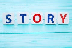 Word story on blue wooden table. Selective focus and copy space royalty free stock image Word story on blue wooden table. Selective focus and copy space royalty free stock image