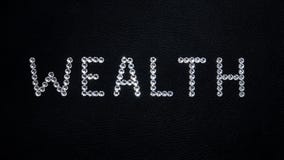 Word Wealth made of shiny white swarovski crystals placed on black leather stock illustration Word Wealth made of shiny white swarovski crystals placed on black leather stock illustration