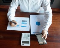 Work advice Working using a phone calculator stock images Work advice Working using a phone calculator stock images
