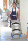 Worker carrying barrel with beer at brewery stock images Worker carrying barrel with beer at brewery stock images