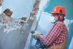 Worker with demolition hammer breaking interior wall royalty free stock photo Worker with demolition hammer breaking interior wall royalty free stock photo