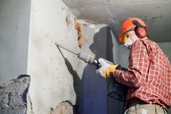 Worker with demolition hammer breaking interior wall royalty free stock photos Worker with demolition hammer breaking interior wall royalty free stock photos