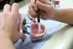 Worker Producing Fake Teeth Stock Photography Worker Producing Fake Teeth Stock Photography