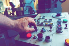 The worker uses the control panel of the CNC machine to process the material. stock photo The worker uses the control panel of the CNC machine to process the material. stock photo