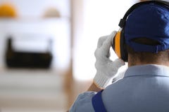 Worker Wearing Safety Headphones Indoors, Back View With Space For Text. Hearing Protection Device Stock Images