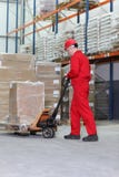 Worker at work with hand powered pallet jack stock image Worker at work with hand powered pallet jack stock image