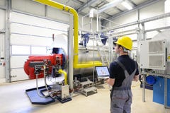 Workers in an industrial plant check the systems with modern tec Stock Images Workers in an industrial plant check the systems with modern tec Stock Images