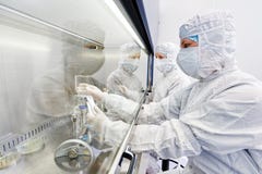 Workers in protective uniform at laboratory stock photo Workers in protective uniform at laboratory stock photo