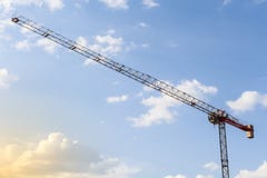 Working with a crane. Construction crane tower on blue sky background. Empty Space for text. Construction concept. Tower crane royalty free stock image Working with a crane. Construction crane tower on blue sky background. Empty Space for text. Construction concept. Tower crane royalty free stock image