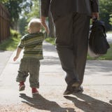 Working Dad walking with son. Professional man walking his child to school or daycare Working Dad walking with son. Professional man walking his child to school or daycare