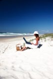 Working on my tan. Woman with laptop on the beach Working on my tan. Woman with laptop on the beach