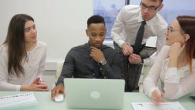 Working team is talking, sitting at desk with laptop in company. stock video footage Working team is talking, sitting at desk with laptop in company. stock video footage