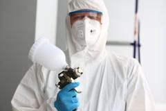 Workman hold in arm airbrush gun wearing protective suit stock photos Workman hold in arm airbrush gun wearing protective suit stock photos