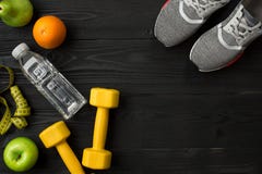 Workout plan with fitness food and equipment on dark background, top view stock photography Workout plan with fitness food and equipment on dark background, top view stock photography