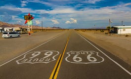 World famous and historic Route 66 signs on road at iconic Roy`s Motel and Cafe in Amboy, California royalty free stock photo World famous and historic Route 66 signs on road at iconic Roy`s Motel and Cafe in Amboy, California royalty free stock photo