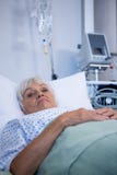 Worried senior patient lying on bed royalty free stock photography Worried senior patient lying on bed royalty free stock photography