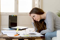 Worried woman suffering stress doing domestic accounting paperwork bills and invoices royalty free stock photography Worried woman suffering stress doing domestic accounting paperwork bills and invoices royalty free stock photography