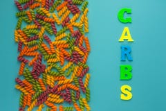 Writing text showing carb of multicolored letters. Colorful background. Abstract set on colorful backdrop with colored pasta royalty free stock image Writing text showing carb of multicolored letters. Colorful background. Abstract set on colorful backdrop with colored pasta royalty free stock image