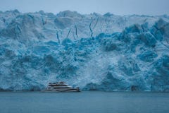 Yacht against blue ice of glacier royalty free stock photography Yacht against blue ice of glacier royalty free stock photography