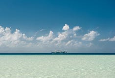 Yacht and blue water ocean.Ocean and perfect sky.Blue sea and clouds on sky. Tropical beach in maldives island Stock Photos Yacht and blue water ocean.Ocean and perfect sky.Blue sea and clouds on sky. Tropical beach in maldives island Stock Photos