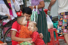 Myanmese father and 2 children with thanakha Myanmar powder on their faces, playing fun happily together in the market royalty free stock photos Myanmese father and 2 children with thanakha Myanmar powder on their faces, playing fun happily together in the market royalty free stock photos