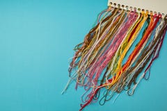Yarn thread and knit sample color set on blue striped background royalty free stock photos Yarn thread and knit sample color set on blue striped background royalty free stock photos