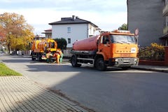 Yaslo, Poland - 9 9 2018: Sewage clearing by special technical means on the streets of a small European town. Orange cars and muni royalty free stock images Yaslo, Poland - 9 9 2018: Sewage clearing by special technical means on the streets of a small European town. Orange cars and muni royalty free stock images