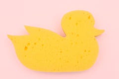 Yellow duck sponge on a pink background. view from above. baby bath sponge. royalty free stock photo Yellow duck sponge on a pink background. view from above. baby bath sponge. royalty free stock photo