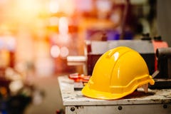 Yellow helmet hardhat safety for factory worker working in danger workplace with space for text