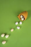 Yellow mug with Easter eggs, green floor royalty free stock image Yellow mug with Easter eggs, green floor royalty free stock image