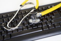 Yellow Phonendoscope And Black Keyboard Stock Images Yellow Phonendoscope And Black Keyboard Stock Images