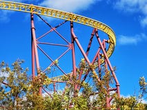 A yellow and red roller coaster track against a deep blue sky. royalty free stock images A yellow and red roller coaster track against a deep blue sky. royalty free stock images