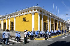 Yellow street corner and students in uniform, Arequipa, Peru