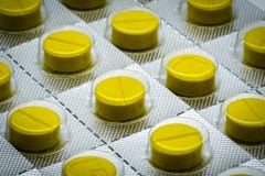 Yellow tablets pill in blister pack. Full frame of tablet pills royalty free stock images Yellow tablets pill in blister pack. Full frame of tablet pills royalty free stock images