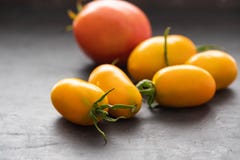 Yellow Tomatoes as high detailed close-up shot on wooden table selective focus. stock photos Yellow Tomatoes as high detailed close-up shot on wooden table selective focus. stock photos