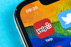 Yelp application icon on Apple iPhone X screen close-up. Yelp app icon. Yelp.com application. Social network. Social media