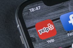 Yelp application icon on Apple iPhone X screen close-up. Yelp app icon. Yelp.com application. Social network. Social media