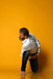Yoga de pratique de vieil homme faisant étirant des exercices sur le fond jaune image libre de droits Yoga de pratique de vieil homme faisant étirant des exercices sur le fond jaune image libre de droits