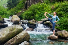 Woman doing Ashtanga Vinyasa Yoga asana outdoors at waterfall royalty free stock image Woman doing Ashtanga Vinyasa Yoga asana outdoors at waterfall royalty free stock image