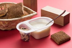 Yogurt with chocolate balls. Double plastic cup with white yogurt and sweet cinnamon cookies. stock photo Yogurt with chocolate balls. Double plastic cup with white yogurt and sweet cinnamon cookies. stock photo