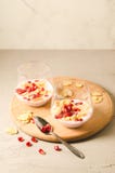 yogurt with garnet grains and flakes in glass/yogurt with garnet grains and flakes in glass on a wooden tray and white stone royalty free stock photo yogurt with garnet grains and flakes in glass/yogurt with garnet grains and flakes in glass on a wooden tray and white stone royalty free stock photo